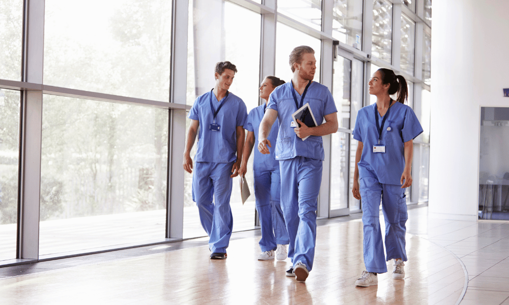 Healthcare workers walking in a corridor 