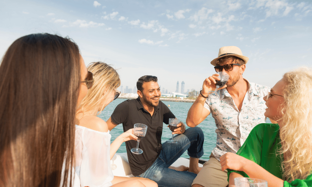 Group of friends enjoying drinks and socialising on a boat in Dubai