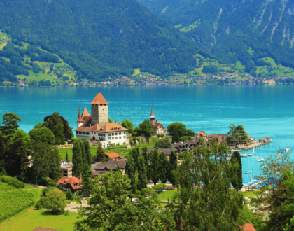 Castle by a lake with mountains in Switzerland.