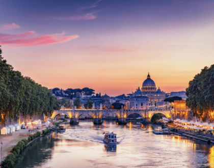 View of St. Peter’s Basilica and the Tiber River at sunset in Rome, Italy