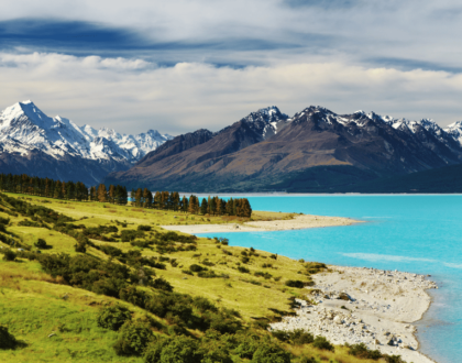 Snow-capped mountains and turquoise lake in New Zealand landscape