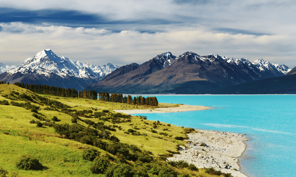 Snow-capped mountains and turquoise lake in New Zealand landscape