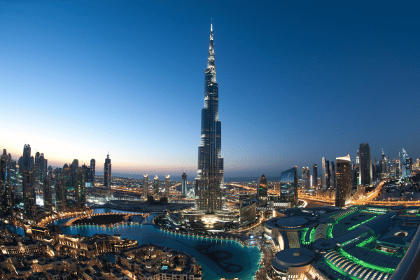 Panoramic view of the Burj Khalifa and downtown Dubai illuminated at dusk.